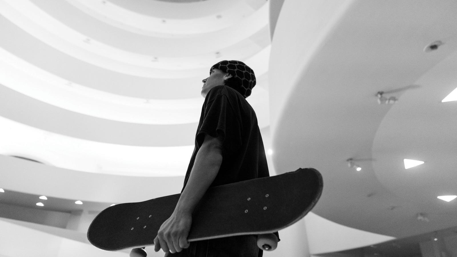 alexis sablone holding a skateboard in the Guggenheim